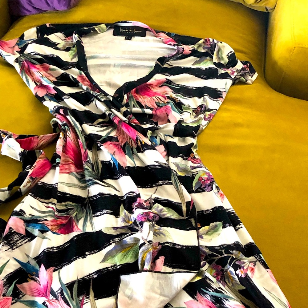Wrap around dress. Beautiful print. Can be dressed up or casual. Never worn.